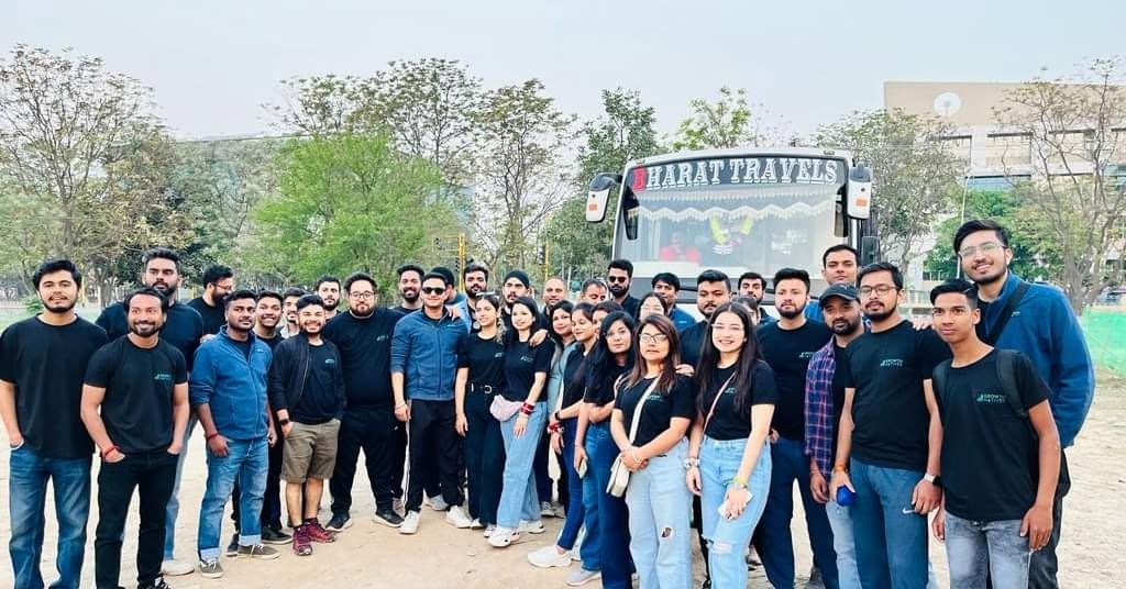 Corporate Group Tour Travelers posing with Bharat Travels Luxury Bus